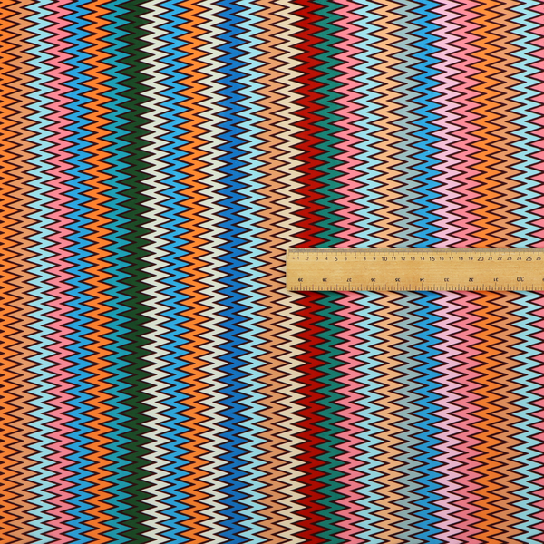 A vibrant fabric pattern featuring tight vertical rows of colourful zigzag lines in shades of orange, pink, blue, red, green, and beige.