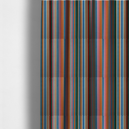 The fabric used to create these made-to-measure curtains is a vibrant fabric pattern featuring tight vertical rows of colourful zigzag lines in shades of orange, pink, blue, red, green, and beige.