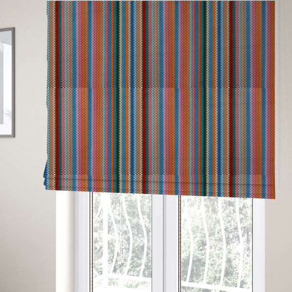 the fabric used to create these Roman blinds is a vibrant fabric pattern featuring tight vertical rows of colourful zigzag lines in shades of orange, pink, blue, red, green, and beige.