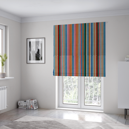 the fabric used to create these Roman blinds is a vibrant fabric pattern featuring tight vertical rows of colourful zigzag lines in shades of orange, pink, blue, red, green, and beige.