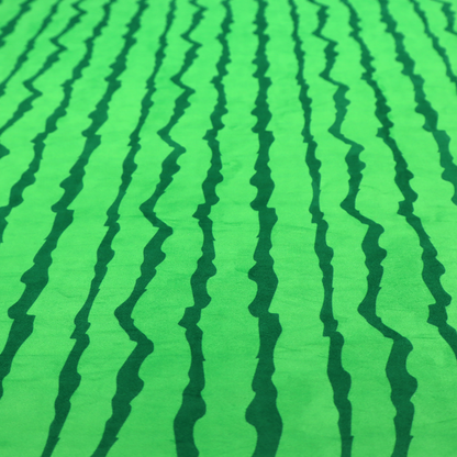 A playful fabric pattern featuring vertical wavy dark green stripes running across a bright green background.