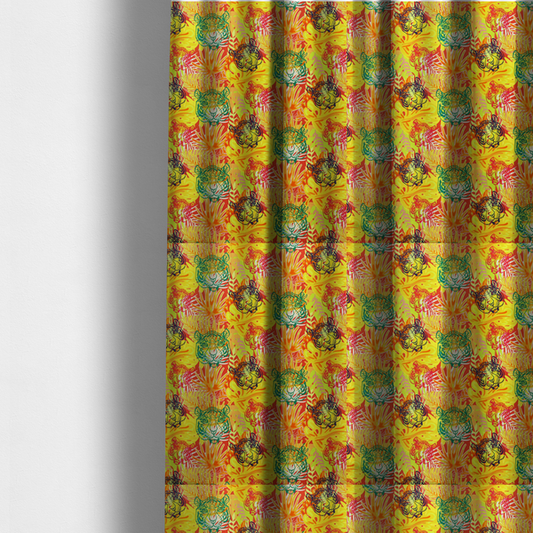 The fabric used to create these made-to-measure curtains features a vibrant, repeating tropical pattern set against a bright yellow and orange background. The design is filled with stylized jungle foliage, including overlapping palm fronds and leaves. Interspersed throughout the pattern are illustrative tiger faces rendered in different colours, including striking shades of green, dark blue, and pinkish-red.   