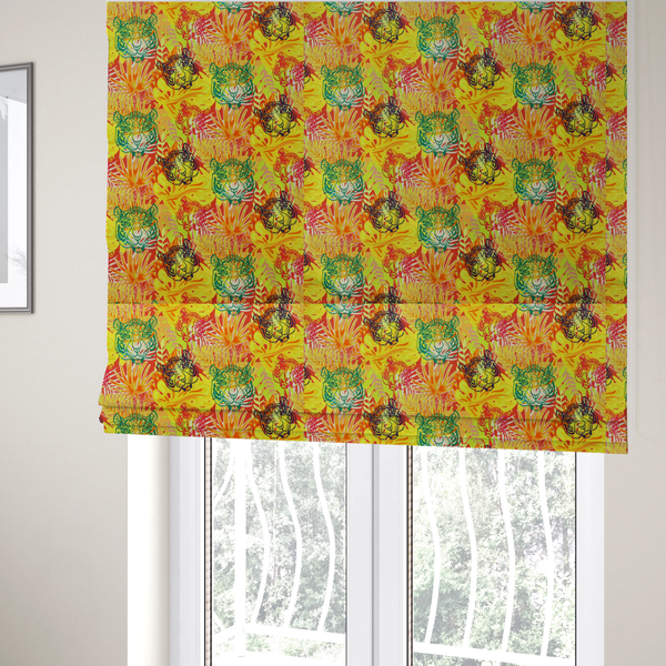The fabric used to create these Roman blinds features a vibrant, repeating tropical pattern set against a bright yellow and orange background. The design is filled with stylized jungle foliage, including overlapping palm fronds and leaves. Interspersed throughout the pattern are illustrative tiger faces rendered in different colours, including striking shades of green, dark blue, and pinkish-red.   