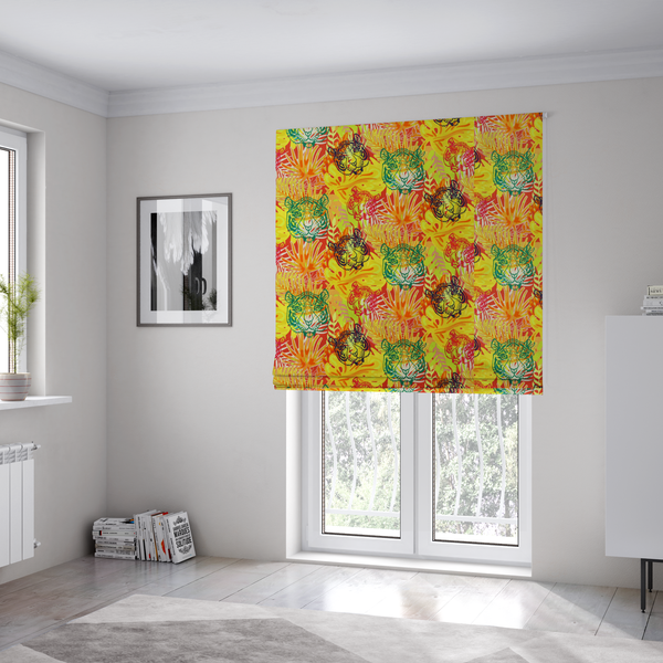 The fabric used to create these Roman blinds features a vibrant, repeating tropical pattern set against a bright yellow and orange background. The design is filled with stylized jungle foliage, including overlapping palm fronds and leaves. Interspersed throughout the pattern are illustrative tiger faces rendered in different colours, including striking shades of green, dark blue, and pinkish-red.   