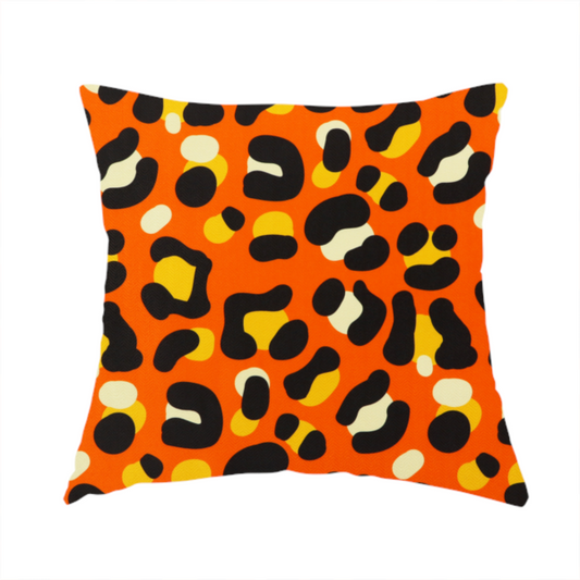 The fabric used to create this handmade cushion features a bold leopard print upholstery fabric in a vibrant orange background with black spots featuring yellow and cream highlights.   
