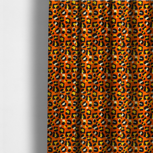 The fabric used to create these made-to-measure curtains features a bold leopard print upholstery fabric in a vibrant orange background with black spots featuring yellow and cream highlights.   