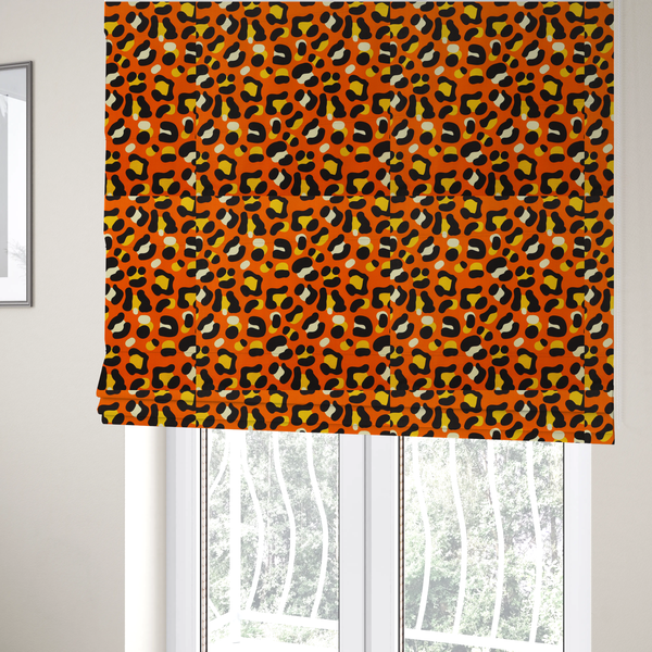 The fabric used to create these Roman blinds features a bold leopard print upholstery fabric in a vibrant orange background with black spots featuring yellow and cream highlights.   