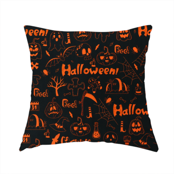 The fabric used to create this handmade cushion features a Halloween-themed repeating pattern set against a black background. The design is filled with spooky orange illustrations, including jack-o'-lanterns, ghosts, skulls, bats, spiderwebs, tombstones, witch hats, and the text "Halloween" and "Boo!"   