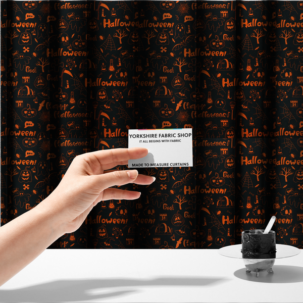 The fabric used to create these made-to-measure curtains features a Halloween-themed repeating pattern set against a black background. The design is filled with spooky orange illustrations, including jack-o'-lanterns, ghosts, skulls, bats, spiderwebs, tombstones, witch hats, and the text "Halloween" and "Boo!"   