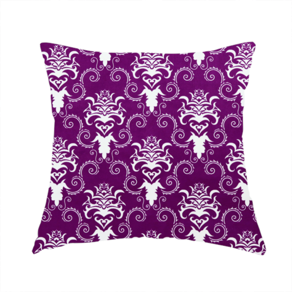 The fabric used to create this handmade cushion features an ornate, repeating damask pattern in white set against a rich purple background.