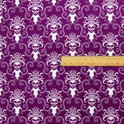 The image features an ornate, repeating damask pattern in white set against a rich purple background.