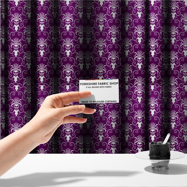 The fabric used to create these made-to-measure curtains features an ornate, repeating damask pattern in white set against a rich purple background.