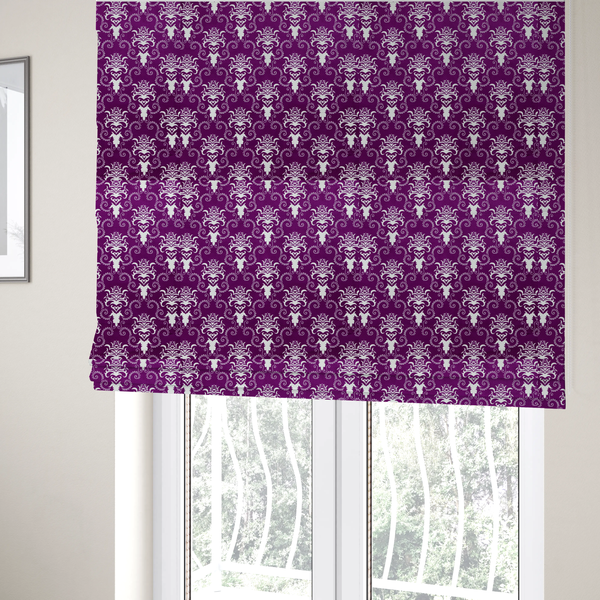 The fabric used to create these Roman blinds features an ornate, repeating damask pattern in white set against a rich purple background.