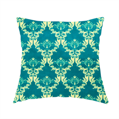 The fabric used to create this handmade cushion features an intricate, repeating damask pattern in a light cream colour set against a textured teal background.   