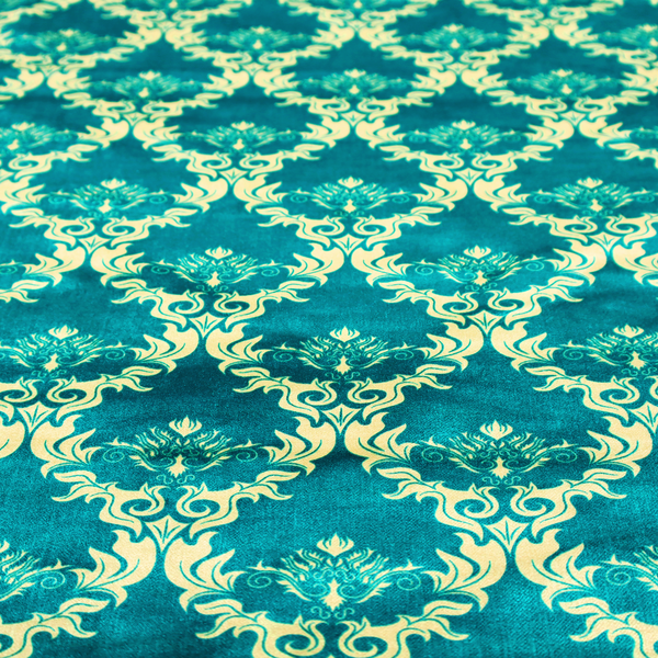 The image features an intricate, repeating damask pattern in a light cream colour set against a textured teal background.   