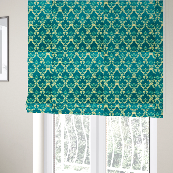 The fabric used to create these Roman blinds features an intricate, repeating damask pattern in a light cream colour set against a textured teal background.   