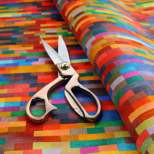 The image features a colourful, mosaic-like pattern made up of small, horizontal rectangular blocks in a wide variety of bright colours, including red, orange, yellow, blue, green, and purple.   