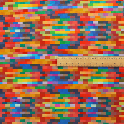 The image features a colourful, mosaic-like pattern made up of small, horizontal rectangular blocks in a wide variety of bright colours, including red, orange, yellow, blue, green, and purple.   