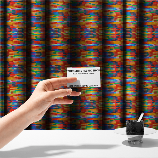 The fabric used to create these made-to-measure curtains features a colourful, mosaic-like pattern made up of small, horizontal rectangular blocks in a wide variety of bright colours, including red, orange, yellow, blue, green, and purple.   
