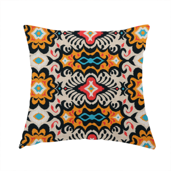 The fabric used to create this handmade cushion features a vibrant, symmetrical ikat-style pattern set against a light background. The design includes elaborate floral motifs and geometric shapes in striking shades of black, orange, yellow, bright red, and turquoise.