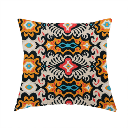 The fabric used to create this handmade cushion features a vibrant, symmetrical ikat-style pattern set against a light background. The design includes elaborate floral motifs and geometric shapes in striking shades of black, orange, yellow, bright red, and turquoise.