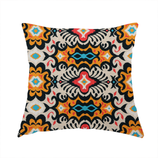 The fabric used to create this handmade cushion features a vibrant, symmetrical ikat-style pattern set against a light background. The design includes elaborate floral motifs and geometric shapes in striking shades of black, orange, yellow, bright red, and turquoise.