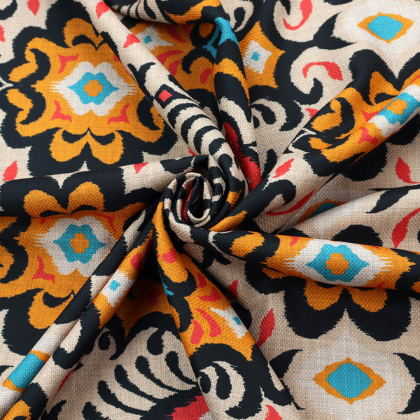 The image features a vibrant, symmetrical ikat-style pattern set against a light background. The design includes elaborate floral motifs and geometric shapes in striking shades of black, orange, yellow, bright red, and turquoise.   