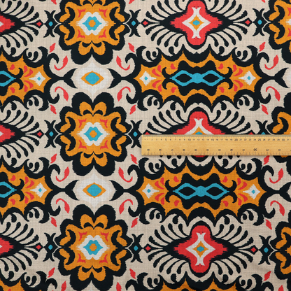 The image features a vibrant, symmetrical ikat-style pattern set against a light background. The design includes elaborate floral motifs and geometric shapes in striking shades of black, orange, yellow, bright red, and turquoise.   
