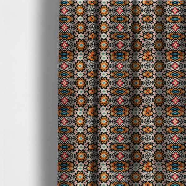 The fabric used to create these made-to-measure curtains features a vibrant, symmetrical ikat-style pattern set against a light background. The design includes elaborate floral motifs and geometric shapes in striking shades of black, orange, yellow, bright red, and turquoise.   