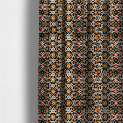 The fabric used to create these made-to-measure curtains features a vibrant, symmetrical ikat-style pattern set against a light background. The design includes elaborate floral motifs and geometric shapes in striking shades of black, orange, yellow, bright red, and turquoise.   