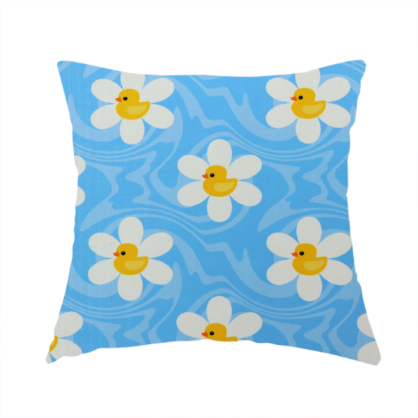 The fabric used to create this handmade cushion features a repeating pattern of white daisies with yellow centres shaped like little rubber ducks, all set against a wavy blue background.   