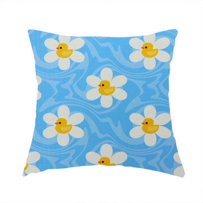 The fabric used to create this handmade cushion features a repeating pattern of white daisies with yellow centres shaped like little rubber ducks, all set against a wavy blue background.   