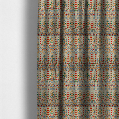 The fabric used to create these made-to-measure curtains features an intricate, traditional-style repeating pattern set against a light, neutral background. The design incorporates teardrop-shaped paisley motifs, arched borders, and horizontal bands filled with floral details in shades of orange, blue, green, and red.   