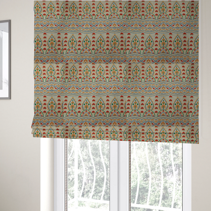 The fabric used to create these Roman blinds features an intricate, traditional-style repeating pattern set against a light, neutral background. The design incorporates teardrop-shaped paisley motifs, arched borders, and horizontal bands filled with floral details in shades of orange, blue, green, and red.   