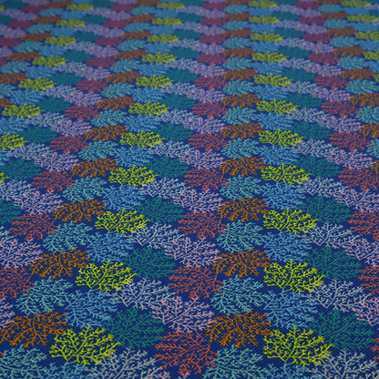 The image features an intricate, dense repeating pattern of sea coral or moss-like clusters set against a deep blue background. The design is filled with detailed organic shapes rendered in various vibrant colours, including lime green, rust orange, teal, and soft pink.