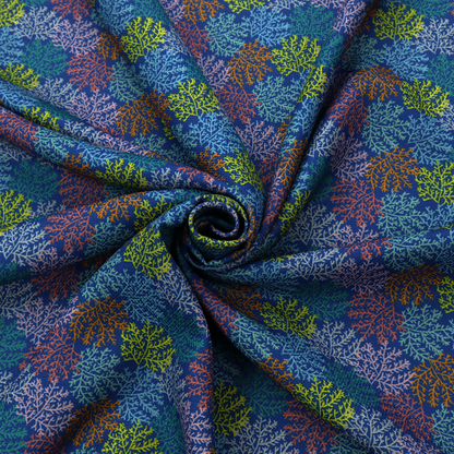The image features an intricate, dense repeating pattern of sea coral or moss-like clusters set against a deep blue background. The design is filled with detailed organic shapes rendered in various vibrant colours, including lime green, rust orange, teal, and soft pink.