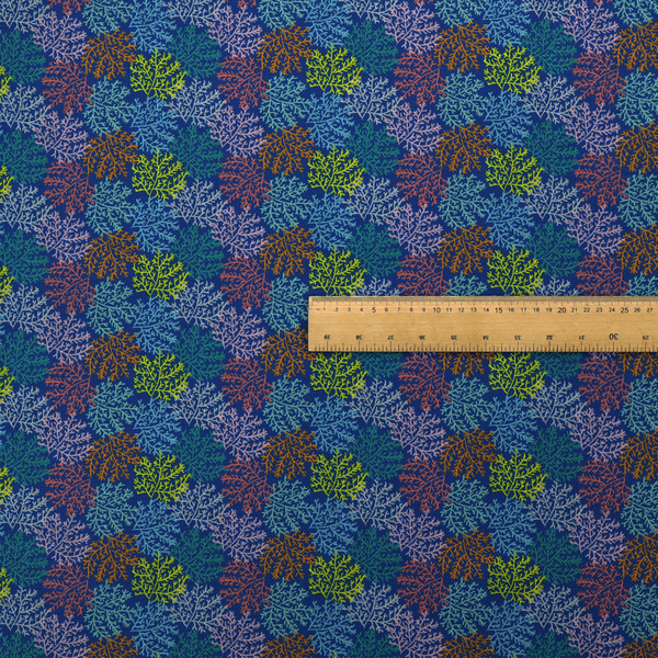 The image features an intricate, dense repeating pattern of sea coral or moss-like clusters set against a deep blue background. The design is filled with detailed organic shapes rendered in various vibrant colours, including lime green, rust orange, teal, and soft pink.