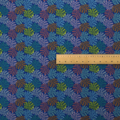 The image features an intricate, dense repeating pattern of sea coral or moss-like clusters set against a deep blue background. The design is filled with detailed organic shapes rendered in various vibrant colours, including lime green, rust orange, teal, and soft pink.
