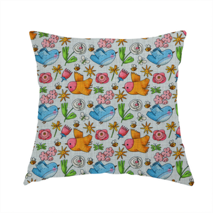 The fabric used to create this handmade cushion features a playful, repeating pattern of whimsical birds, flowers, and bees set against a light background. The whimsical design includes blue and orange-yellow birds, pink and white flowers, and tiny buzzing bees.