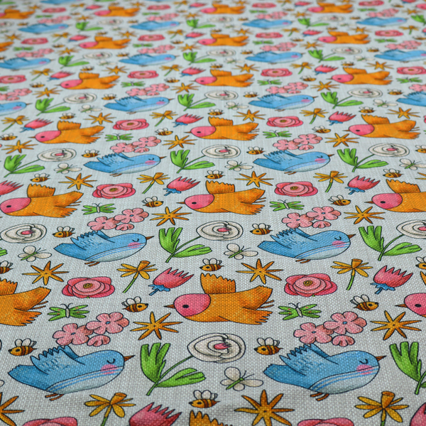 The image features a playful, repeating pattern of whimsical birds, flowers, and bees set against a light background. The whimsical design includes blue and orange-yellow birds, pink and white flowers, and tiny buzzing bees.