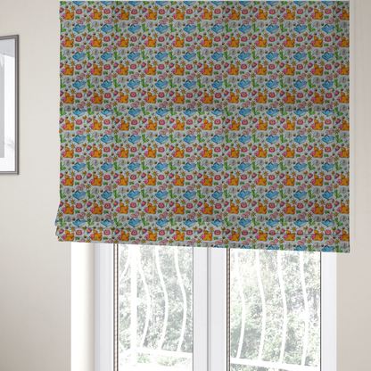 The fabric used to create these Roman blinds features a playful, repeating pattern of whimsical birds, flowers, and bees set against a light background. The whimsical design includes blue and orange-yellow birds, pink and white flowers, and tiny buzzing bees.