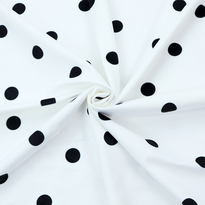 A white fabric pattern featuring evenly spaced black polka dots arranged in horizontal and vertical rows.
