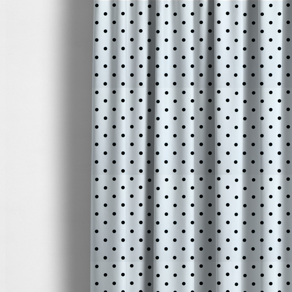 The fabric used to create these made-to-measure curtains is a white fabric pattern featuring evenly spaced black polka dots arranged in horizontal and vertical rows.