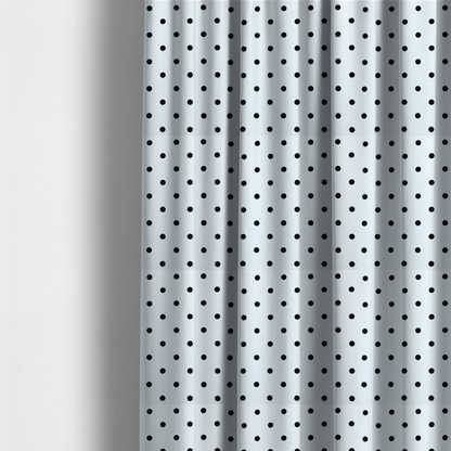The fabric used to create these made-to-measure curtains is a white fabric pattern featuring evenly spaced black polka dots arranged in horizontal and vertical rows.
