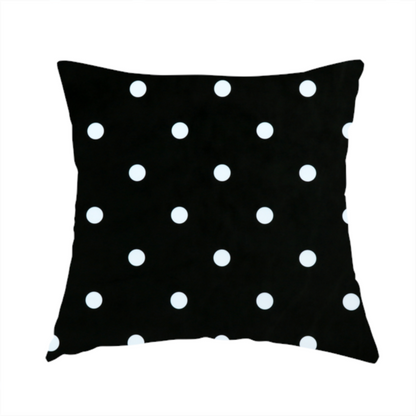 The fabric used to create this handmade cushion is a black fabric pattern featuring evenly spaced white polka dots arranged in horizontal and vertical rows.