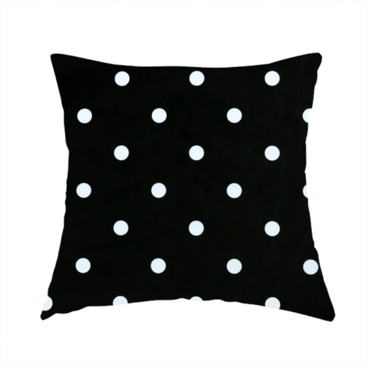 The fabric used to create this handmade cushion is a black fabric pattern featuring evenly spaced white polka dots arranged in horizontal and vertical rows.
