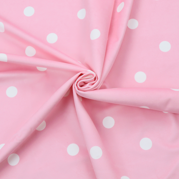 A pink fabric pattern featuring evenly spaced white polka dots arranged in horizontal and vertical rows.