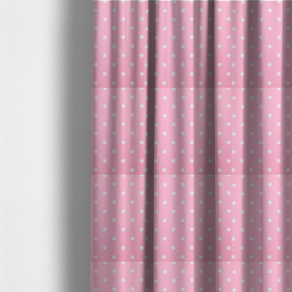 The fabric used to create these made-to-measure curtains is a pink fabric pattern featuring evenly spaced white polka dots arranged in horizontal and vertical rows.
