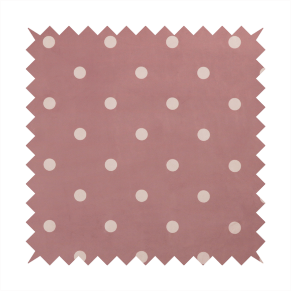 A dusty rose or mauve fabric pattern featuring evenly spaced off-white polka dots arranged in horizontal and vertical rows.
