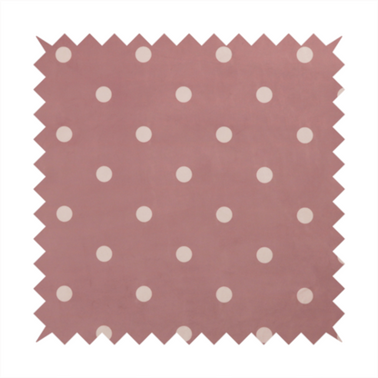A dusty rose or mauve fabric pattern featuring evenly spaced off-white polka dots arranged in horizontal and vertical rows.